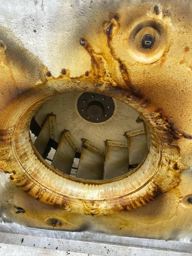 Grease-stained rooftop exhaust fan before cleaning