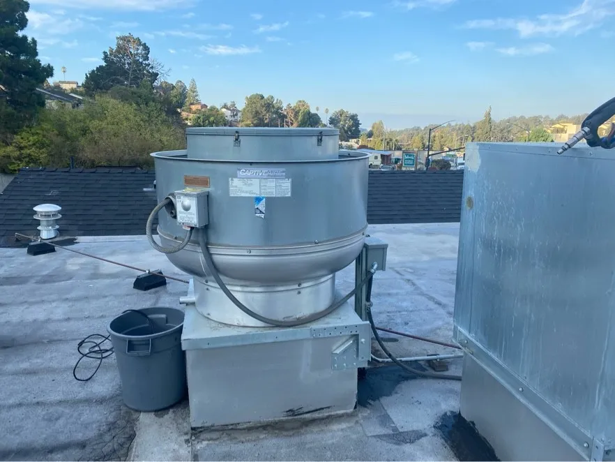 Rooftop upblast exhaust fan on its curb after cleaning